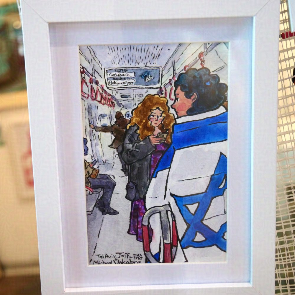 Vertical painting in ink lines and watercolour colours, a scene inside a tram underground. On the right to center, for most of the painting stands a young woman draped in Israeli flag, with indigo-coloured hair. Behind her is another woman, looking at a phone, wearing a black jacked and purple long dress. Behind on the left is sitting passenger with jeans and blue hair, another passenger stands behind both. The screen on top says in English 