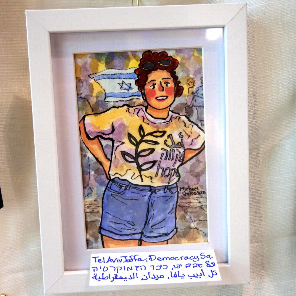 Vertical painting painted in watercolour with ink lines. In the middle stands a young woman with dark orange curly hair, smiling towards the observer. She wears short jeans shirts and a t-shirt with an olive branch and words 