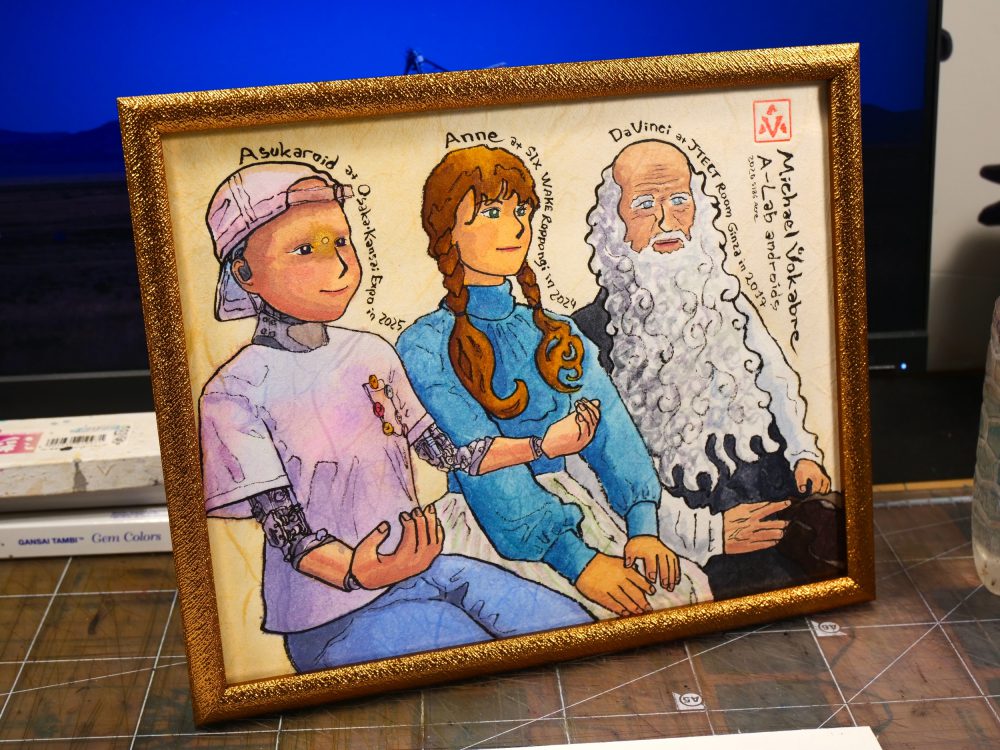 The painting described before is photographed in a golden frame on a work table, a screen behind, so as stacked Japanese paint boxes. The table is covered with a cutting mat underneath which is craft-looking paper.